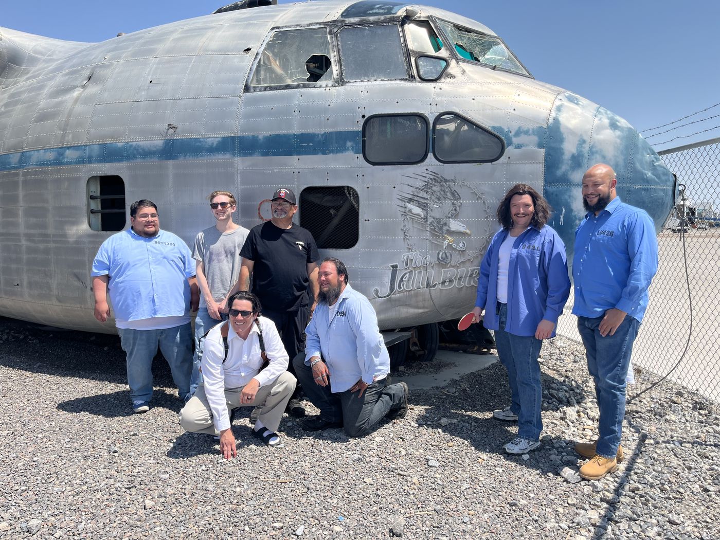 Full cast in costume in front of the retired Con Air aircraft