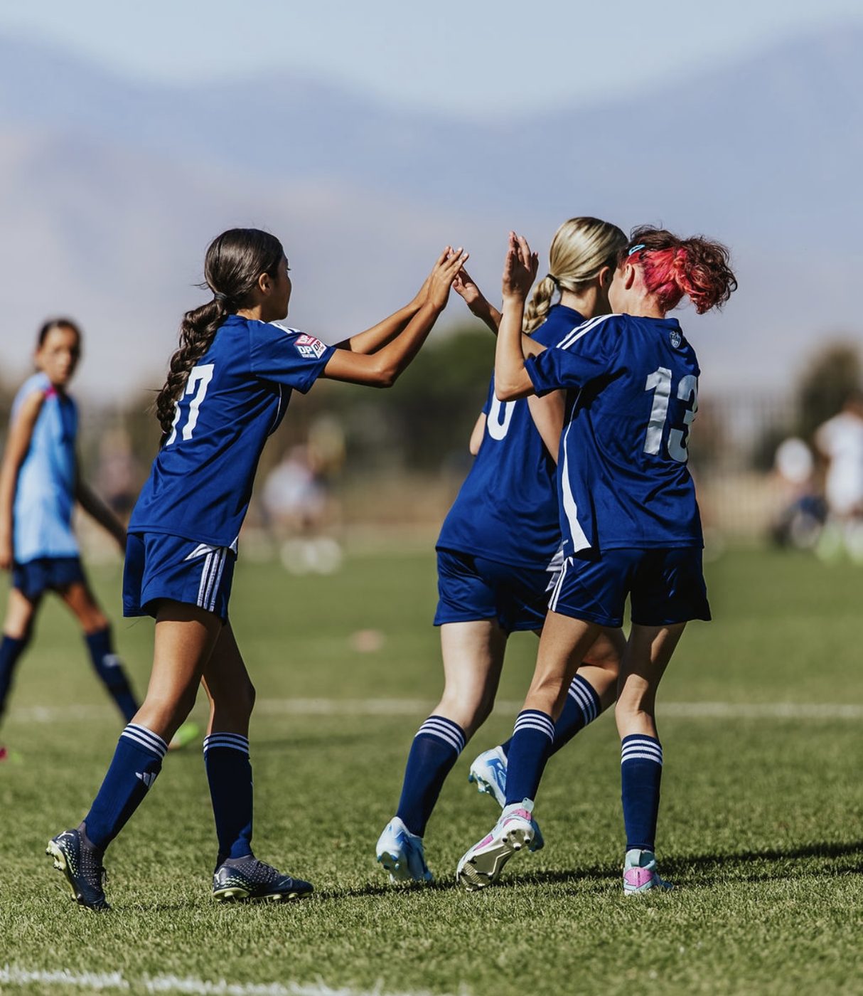 Youth soccer players celebrating on the field